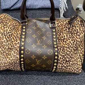 Fun leather repurposed Louie bag with animal print and grommets.